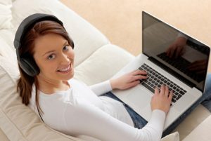 woman-wearing-headphones-on-computer